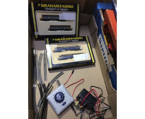 Box containing two Graham Farish model trains, Bachmann controller unit and a quantity of track. Farish miniatures are 158 2 
