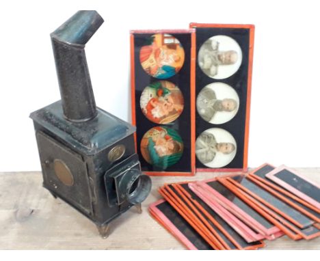 A tin plate Standard EP candle powered slide projector with slides. 