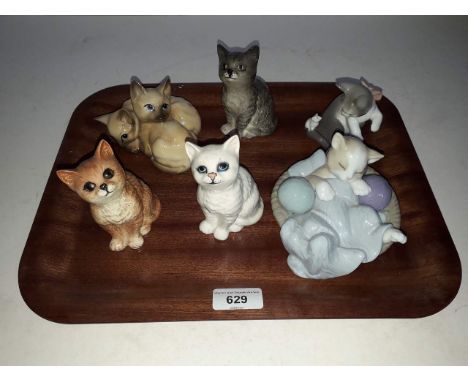 A group of cat models comprising four 1960s Beswick, one Lladro and one Nao. 