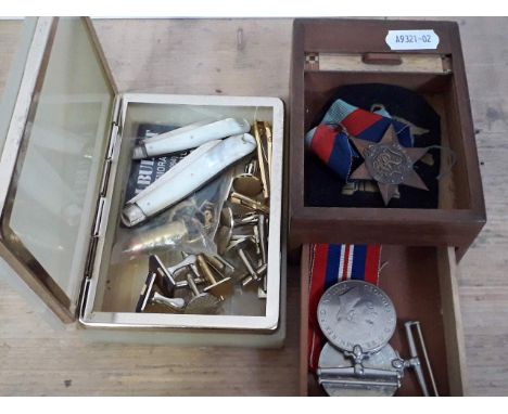 Assorted items comprising a WWII trio, two hallmarked silver and mother of pearl fruit knives, bullets cufflinks etc. 