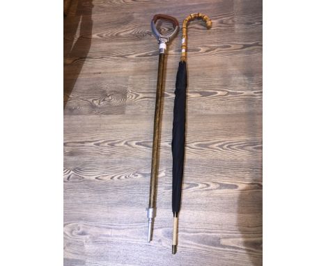 A shooting stick and a bamboo handled umbrella 