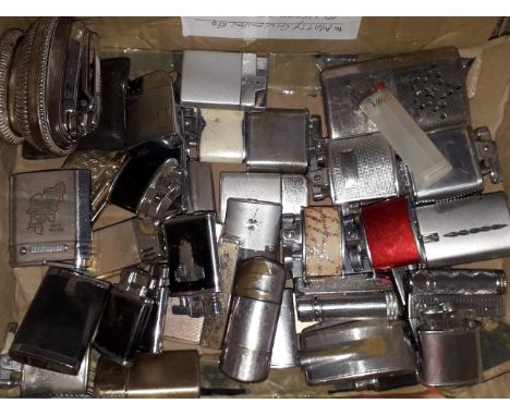 A box containing approximately 42 vintage cigarette lighters. 