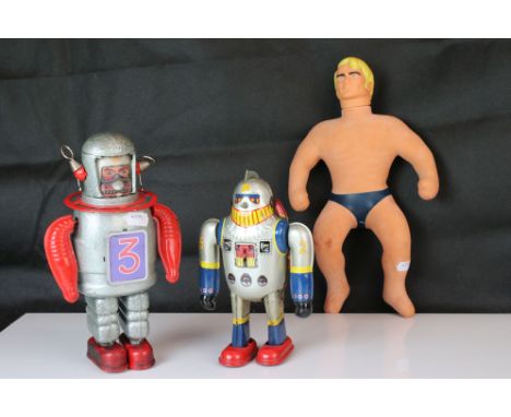 Two tinplate clockwork toys, one in the design of a robot and the other an astronaut, plus a playworn Hasbro Stretch Armstron