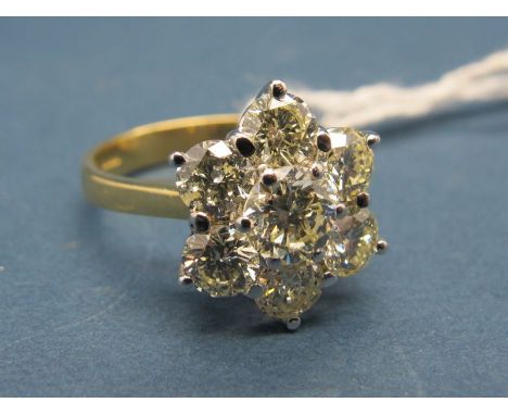 An 18ct Gold Seven Stone Diamond Cluster Ring, of flowerhead design, claw set with brilliant cut stones. 