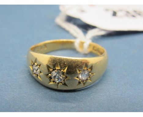 An 18ct Gold Three Stone Ring, graduated star set to the front. 