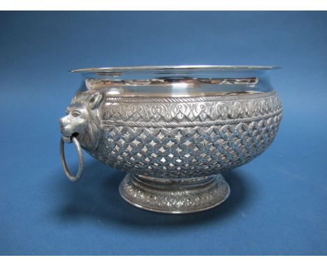 A Middle Eastern Bowl, allover foliate pierced, between twin lion mask and ring handles, raised on circular spreading base, 1