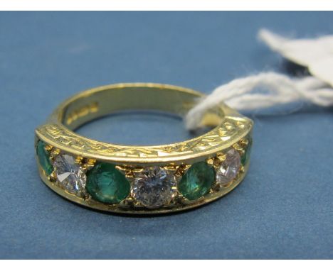 An 18ct Gold Emerald and Diamond Seven Stone Ring, alternately set within engraved setting and engraved shank. 