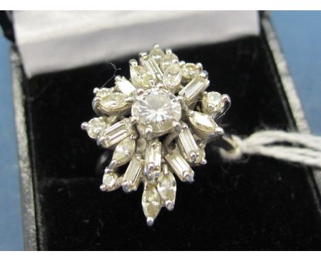 A Diamond Set Cocktail Ring, claw set to the centre with a brilliant cut stone, within claw set shaped border of baguette, ma