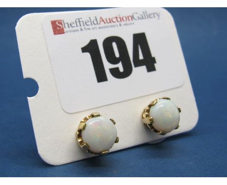 A Pair of Single Stone Opal Earstuds, each circular cabochon claw set. 