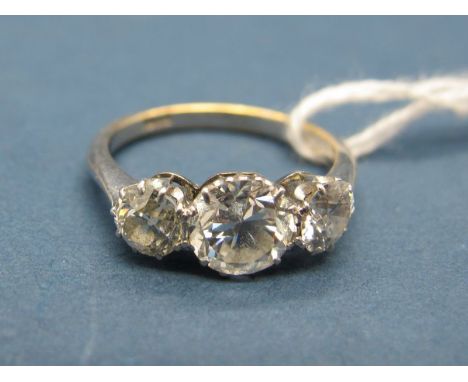 A Three Stone Diamond Ring, claw set with three graduated old cut stones, stamped "18ct". 