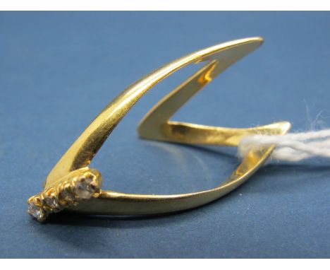 A Wishbone Ring, of elongated design with claw set highlights, stamped "18ct". 
