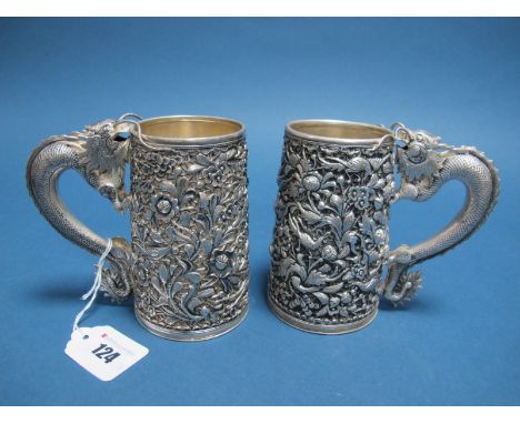 A Pair of Chinese Mugs, each of tapering cylindrical form, allover detailed in relief with exotic birds and flowers, and sinu