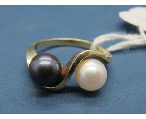 A Modern Pearl Set Dress Ring, set with black and white pearls, of crossover twist design, stamped "585". 