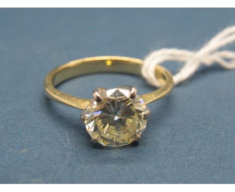 A Single Stone Diamond Ring, the (8mm) brilliant cut stone claw set, stamped "750". 