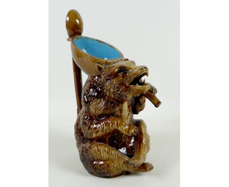 A late 19th century German pottery novelty pitcher jug, modelled as a seated bear, mouth open from which the fluid would pour