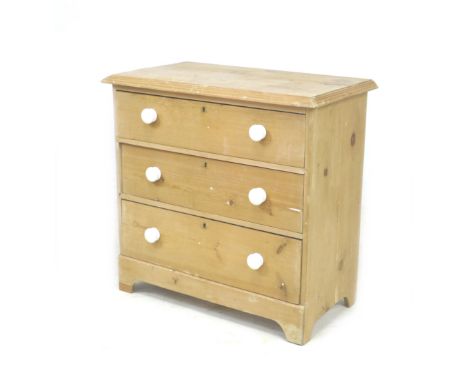 An early 20th century pine chest of three drawers, raised on bracket feet with white ceramic handles, 82.5 by 46 by 80.5cm hi