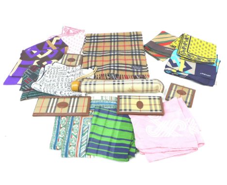A collection of Burberrys textile accessories, comprising an umbrella, two wallets, a chequebook holder, a purse and a Burber