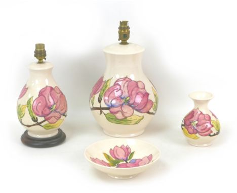 Four pieces of Moorcroft Pottery Magnolia pattern wares, including two table lamps, largest, 18 by 31cm high, a spill vase, 1