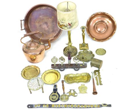 A group of copper and brass items, including horse brasses, jam pan, kettle, decorative charger, trivet, candlestick, table l