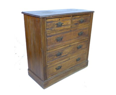 An Edwardian walnut chest of two short over three long graduating drawers, with brass plate handles and line carved decoratio