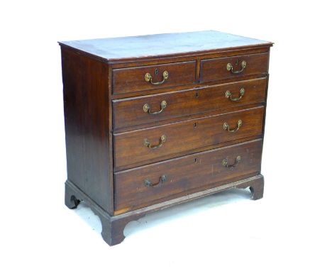 A Georgian mahogany chest of drawers, two short over three long drawers, with brass swan neck handles, raised on bracket feet