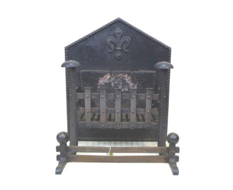 A 17th century cast iron fire grate, the pointed arch back centred by a fleur-de-lys over an inset stone, high front legs wit