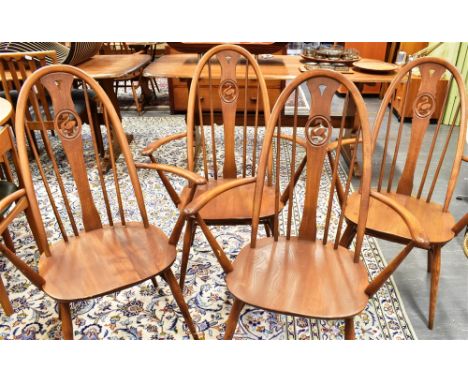 A SET OF FOUR ERCOL 'SWAN BACK' WINDSOR ARMCHAIRS Condition Report : solid, but tatty in places, would benefit from refurbish