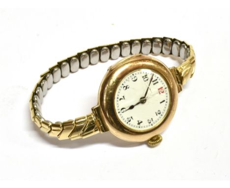 A VINTAGE WATCH  circular yellow metal case 2.9cm in diameter, white enamel dial, black Arabic numerals (red 12) and batons e