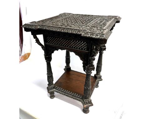 AN ANGLO-INDIAN/MOORISH CARVED HARDWOOD OCCASIONAL TABLE  in the manner of Liberty's, the square shaped top profusely decorat