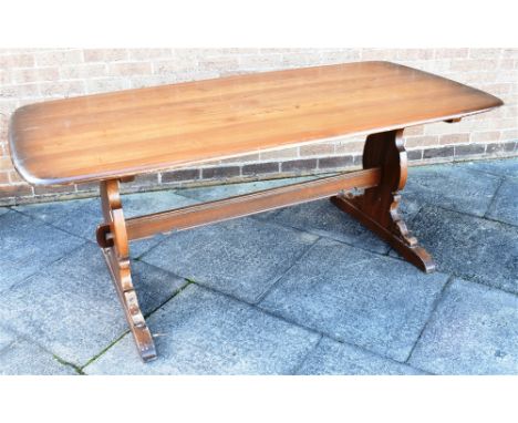 AN ERCOL REFECTORY DINING TABLE  the rectangular top 88cm x 183cm, on shaped supports united by strecher Condition Report : o