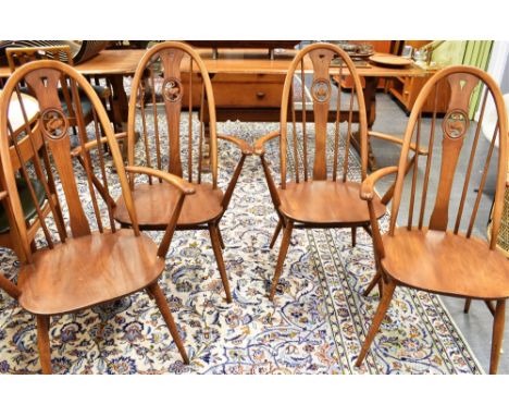 A SET OF FOUR ERCOL 'SWAN BACK' WINDSOR ARMCHAIRS Condition Report : solid, but tatty in places, would benefit from refurbish