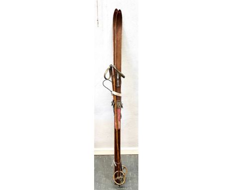 A PAIR OF VINTAGE 'TOR' WOODEN SKIS  120cm high, and pair of bamboo ski sticks Condition Report : agr related wear and tear, 