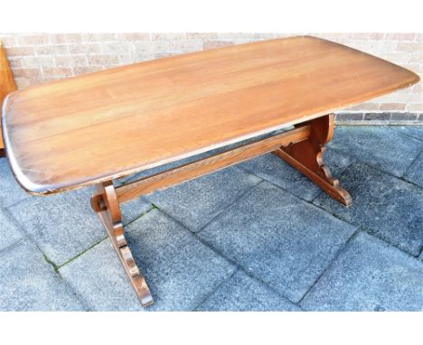 AN ERCOL REFECTORY DINING TABLE  the rectangular top 88cm x 183cm, on shaped supports united by strecher Condition Report : o