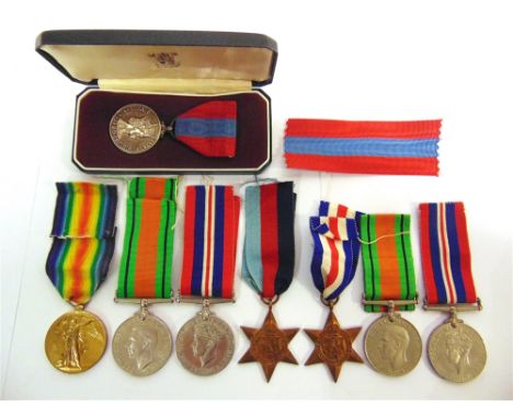 MILITARIA - A FAMILY MEDAL GROUP   comprising a Great War Victory Medal (44093 PTE. C.L. PAYNE. R. SCOTS.), officially impres