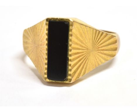 A VINTAGE 9CT GOLD SIGNET RING  vertical rectangular black hardstone bezel, wide star patterned shoulders, London hallmark, r