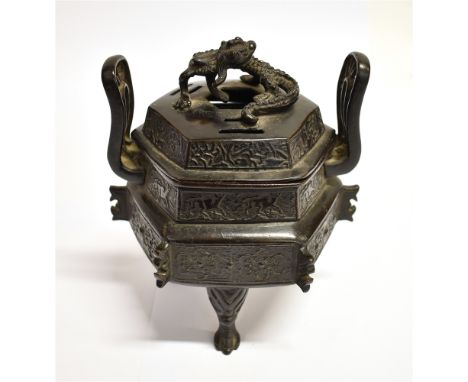 A CHINESE BRONZE TWO HANDLED KORO AND COVER  of archaic hexagonal form, the pierced lid applied with dragon, 15cm high Condit
