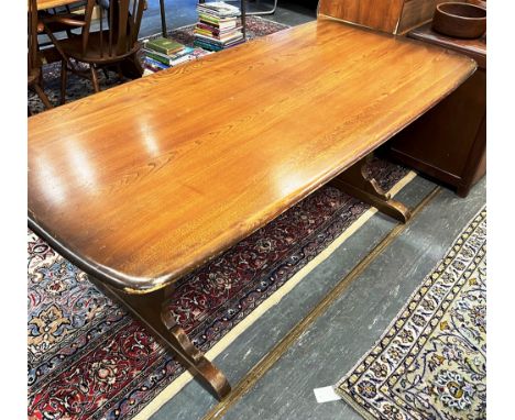 AN ERCOL REFECTORY DINING TABLE  the rectangular top 88cm x 183cm, on shaped supports united by strecher Condition Report : o