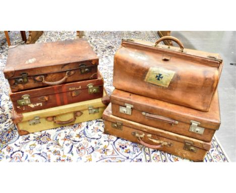 A COLLECTION OF VINTAGE LUGGAGE:  five various suitcases including canvas and leather examples, and a Gladstone bag Condition