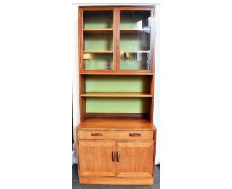 A G-PLAN TEAK WALL UNIT  the upper section with glazed doors enclosing two adjsutable shelves above another adjustable shelf,