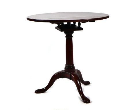 A 19th century mahogany tripod table with bird cage movement on tapering cylindrical column on triform base with slipper feet