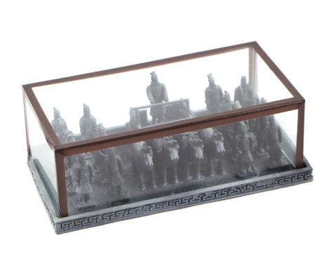 A small diorama of the Chinese Terracotta Army in a glazed display case, 18cms wide.