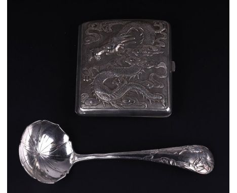 A Chinese white metal cigarette case decorated in relief with a dragon and flowers, the shield shaped cartouche inscribed 'J 