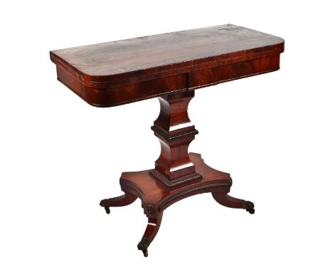 A Regency mahogany card table, the fold-over rounded rectangular  top on an architectural column, with quatrefoil rectangular