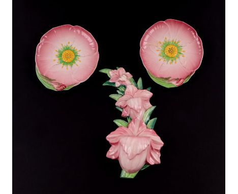 A Carltonware wall pocket in the form of a spray of flowers, 30cms high; together with a pair of moulded flower petal dishes,