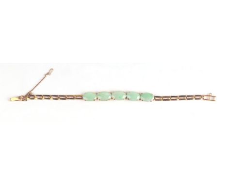 A Chinese high carat gold and pale green jade panel bracelet, 13.3g.