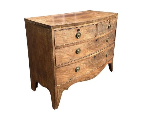 A George III mahogany bowfront chest of drawers with an arrangement of two short and two graduated long drawers above a shape