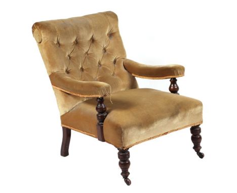 A Victorian upholstered button back open armchair on ring turned front legs.