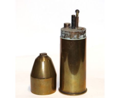 A Boer War trench art table top petrol lighter made from a period brass shell case. Stamped to the base: EP 97. Diameter at t