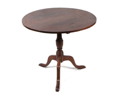 A 19th century oak tilt-top tripod table with turned column, on triform base with slipper feet, 78cms diameter.