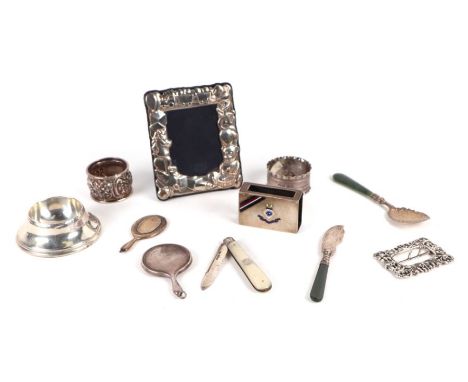 A small quantity of silver items to include a Victorian nurses buckle, London 1894; together with a silver and enamel match b